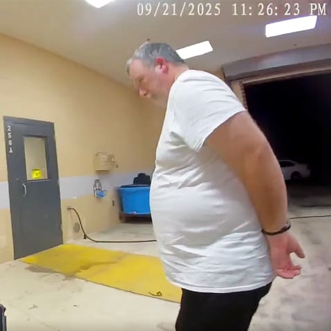 Larry Bushart in handcuffs from the police body cam footage.