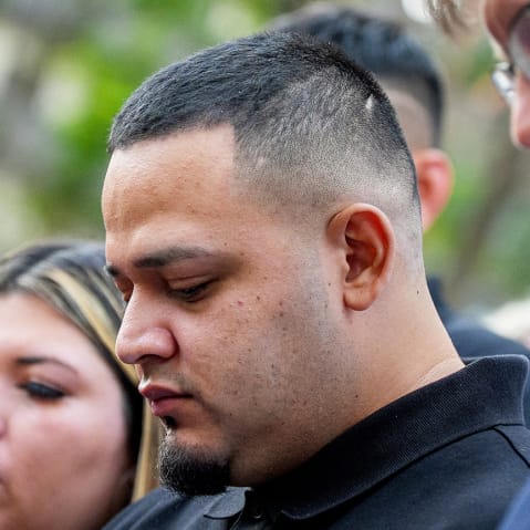 Kilmar Abrego Garcia (C), Rep. Glenn Ivey (L), Garcia's wife Jennifer Vasquez Sura (2nd-L), and his lawyer Simon Sandoval-Moshenberg (R) participates in a prayer vigil for him before he enters a U.S. Immigration and Customs Enforcement (ICE) field office.