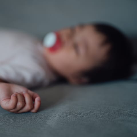 A sleeping baby, out of focus.