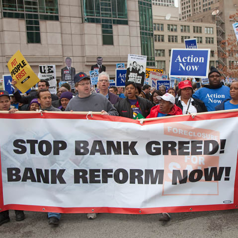 Unions, religious groups, and community organizations in Chicago rally outside the conference of the American Bankers Association.