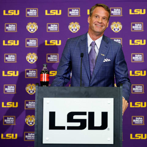 Lane Kiffin stands behind a podium at a press conference at Tiger Stadium in Baton Rouge, L.A.