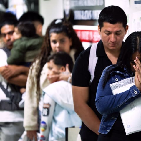 People wait in line before their hearings at the New York Federal Plaza Immigration Court in New York City.