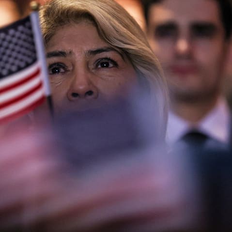 People celebrate becoming U.S. citizens at a naturalization ceremony in Riverside, C.A.