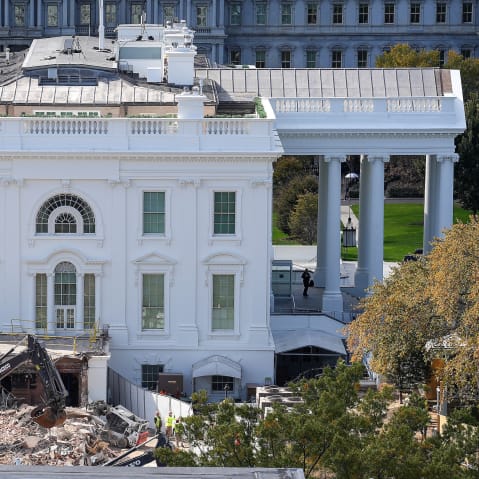 An excavator works to clear rubble after the East Wing of the White House was demolished on Oct. 23, 2025.
