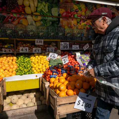 A man walks by a food market in New York City.