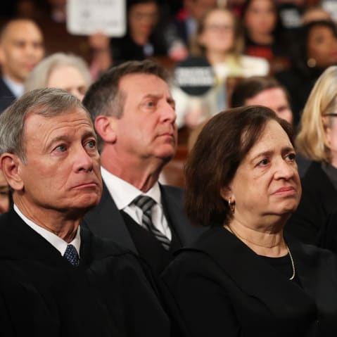 Justice Elena Kagan sits between Chief Justice of the Supreme Court John Roberts and Justice Brett Kavanaugh.