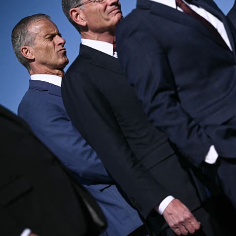 Senate Majority Leader John Thune, left, attends a news conference with Republican Congressional leadership, all dressed in suits, outside the Capitol.