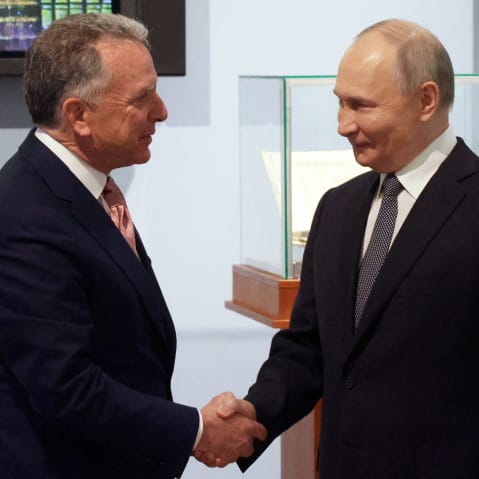Russia's President Vladimir Putin shakes hands with US President Donald Trump's envoy Steve Witkoff.
