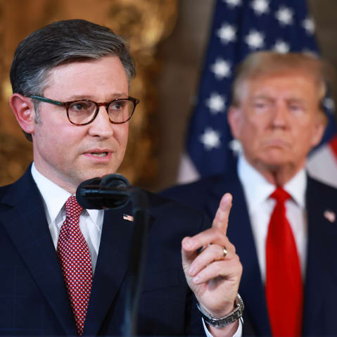 US President Donald Trump listens as Speaker of the House Mike Johnson speaks during a press conference.
