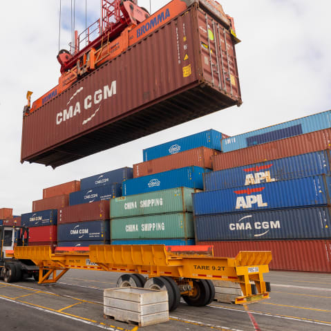 Cranes unload shipping containers at the Port of Los Angeles.