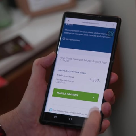 A cell phone health insurance app shows a bill