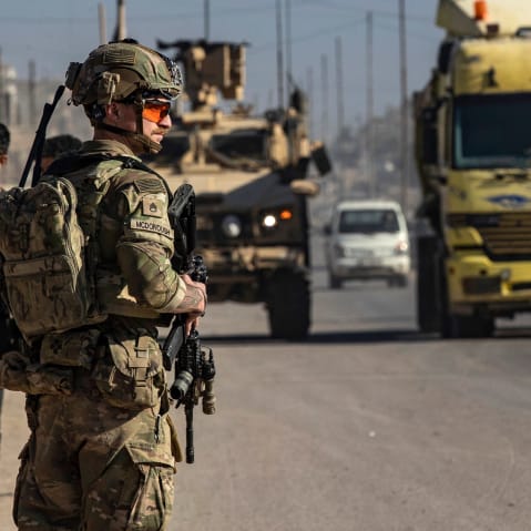 A US soldier keeps watch during a patrol in Syria.