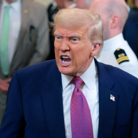 President Donald Trump responds to a reporter's question.