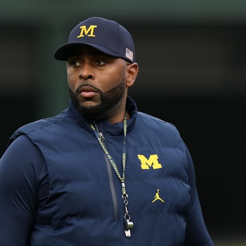 Former University of Michigan Sherrone Moore of the Michigan Wolverines observes practice prior to a game.