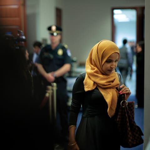 Rep. Ilhan Omar at the Capitol, with a police officer in the background