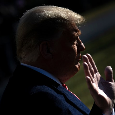 President Donald Trump puts his hand up on the South Lawn of the White House on Jan. 12, 2021.