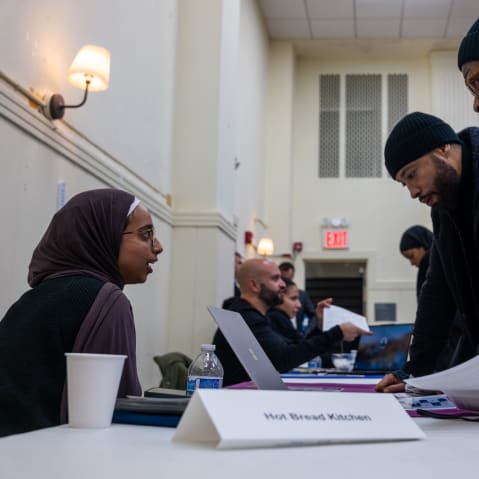 Job seekers attend a career fair in Harlem hosted.