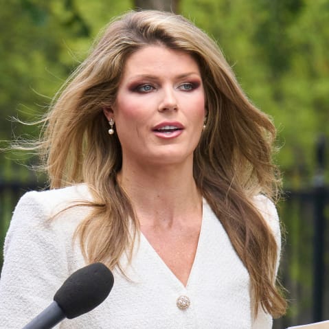 A microphone is held to Lindsey Halligan.