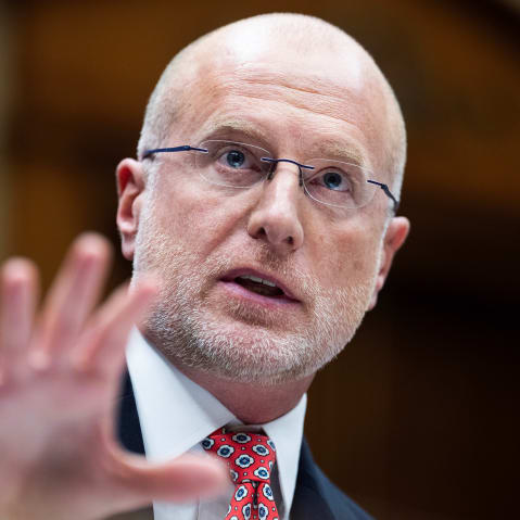 Brendan Carr with his hand out in front of him.