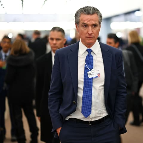 Gavin Newsom walks down a hallway during the World Economic Forum in Davos, Switzerland.
