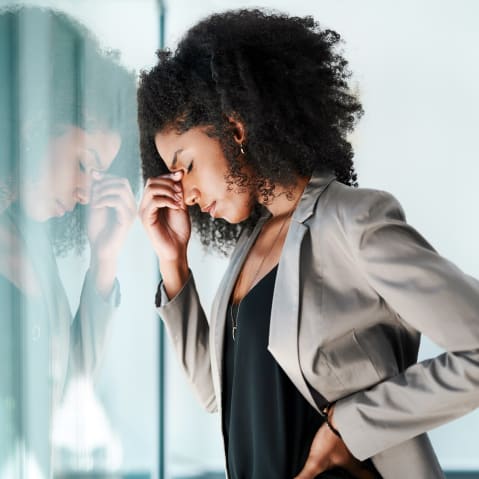 Shot of a young black businesswoman looking stressed out in an office.