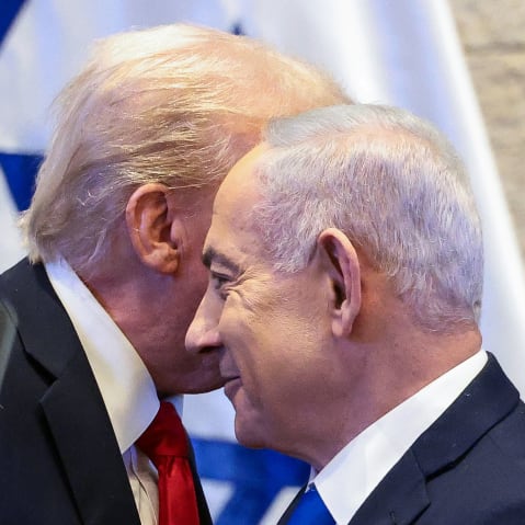 President Donald Trump's face is obscured behind Benjamin Netanyahu's.