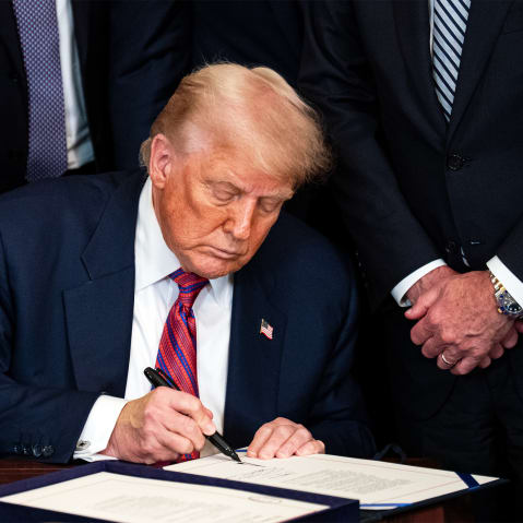 President Donald Trump signing an act on July 18, 2025, during a ceremony in the East Room of the White House.