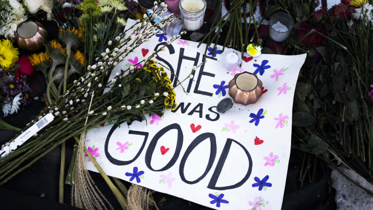 A poster reading "She Was Good" lies at a memorial near the site where Renee Good was killed a week ago, on Jan. 14, 2026 in Minneapolis, MN.