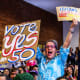 People cheer during a campaign event in support of Prop 50 in San Francisco.