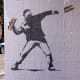Banksy-style posters depicting a man throwing a sandwich in Washington, D.C.