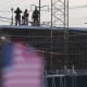 People on the roof of the immigration processing and detention center watch demonstrators in Broadview, I.L.