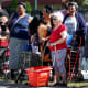 People wait in line to receive groceries from a food bank in Miami, F.L.