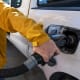 A customer refuels his car at a gas station.