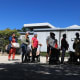 People waiting in line to receive groceries from Curley's House Food Bank.
