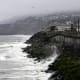 The Pacific Ocean along coastline as a wave crashes onto the land