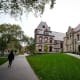 A passer-by walks along a path on the campus of Brown University
