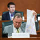 Terry M. Wilson looks through maps during a public hearing