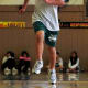 A student runs across the gym floor