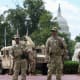 Members of the National Guard stand outside Union Station on Aug. 14, 2025 in Washington, D.C.
