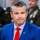 Pete Hegseth looks on during a meeting.