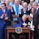 President Donald Trump pounds a gavel presented to him by House Speaker Mike Johnson