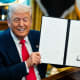 Donald Trump holds up a signed letter