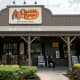 A Cracker Barrel sign featuring the old logo hangs on the outside of a restaurant on Aug. 21, 2025 in Homestead, Fla.