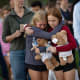 Two girls hug at a vigil on Aug. 27, 2025 for the victims of a shooting at Annunciation Catholic School in Minneapolis
