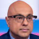 A split composite image of Ali Velshi, left, and a sign with the word billionaires crossed out in a red circle