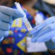 A nurse holds a COVID-19 vaccine in Miami.