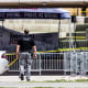 A police officer walks toward the crime scene tent