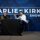 Charlie Kirk conducts a live podcast with Steve Bannon during the AmericaFest 2024 conference in Phoenix, Ariz., on Dec. 19, 2024.