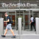 A person enters The New York Times building.