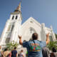 People stand outside of a church building